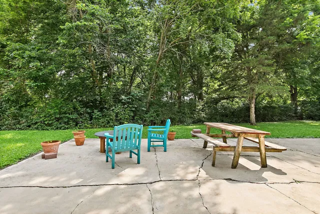 a view of backyard with a table and chairs