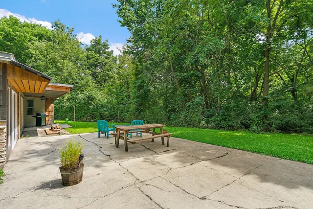 a view of a patio with a table and chairs