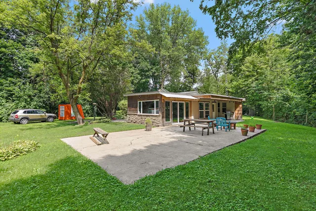 a view of a house with backyard porch and sitting area