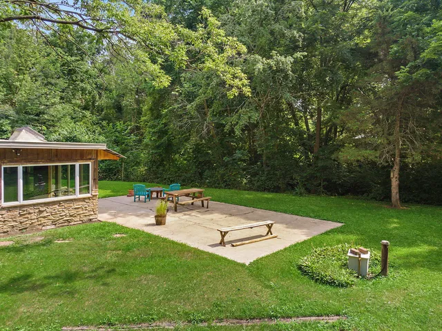 a view of a backyard with sitting area