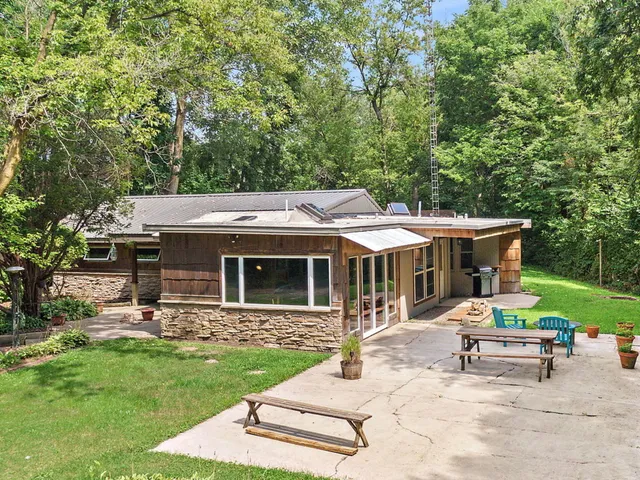 a view of a house with backyard porch and sitting area