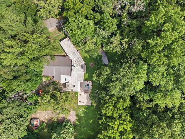 a aerial view of a house with a yard and garden