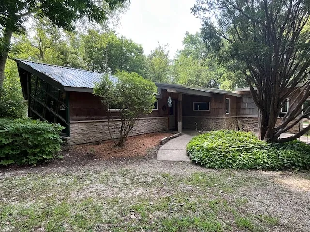 a front view of a house with garden