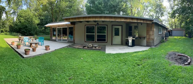 a view of a house with backyard porch and sitting area