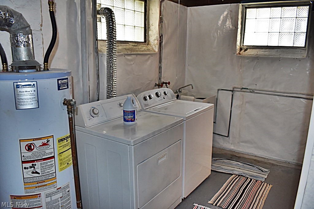 7715 Ackley Road Parma, OH 44129 - Photo 23 of 27 Clothes washing area featuring water heater and washing machine and dryer
