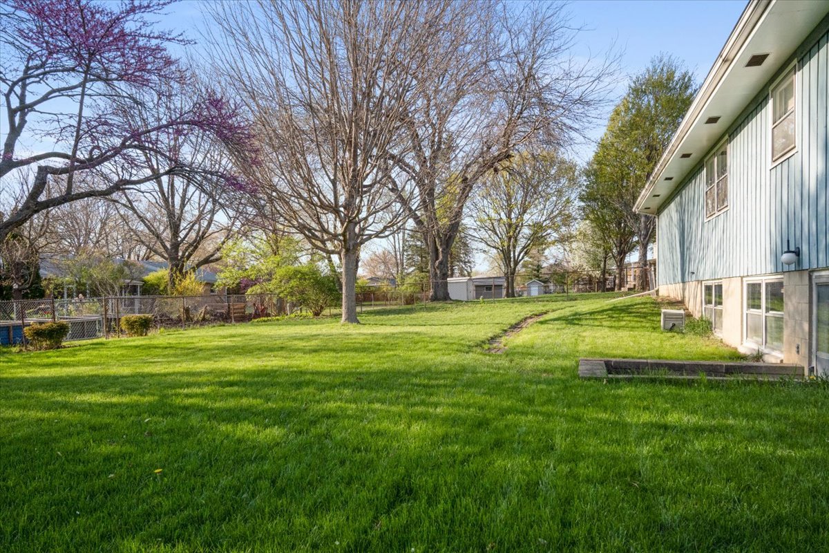 213 Concord Drive Normal, IL 61761 - Photo 21 of 21 a view of a swimming pool with a garden and trees