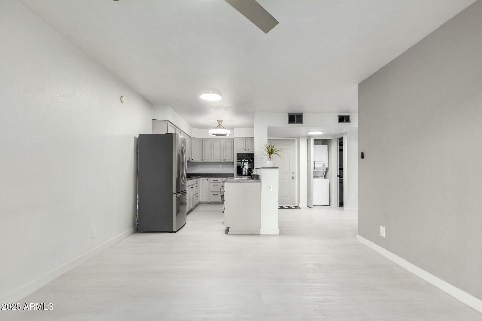 540 North May, Unit 1075 Mesa, AZ 85201 - Photo 11 of 23 a view of a kitchen with refrigerator and microwave