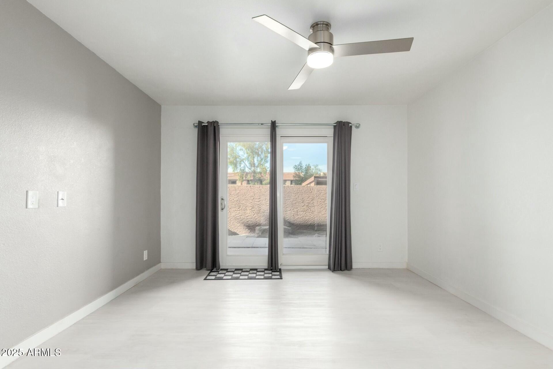 540 North May, Unit 1075 Mesa, AZ 85201 - Photo 18 of 23 an empty room with fan and windows