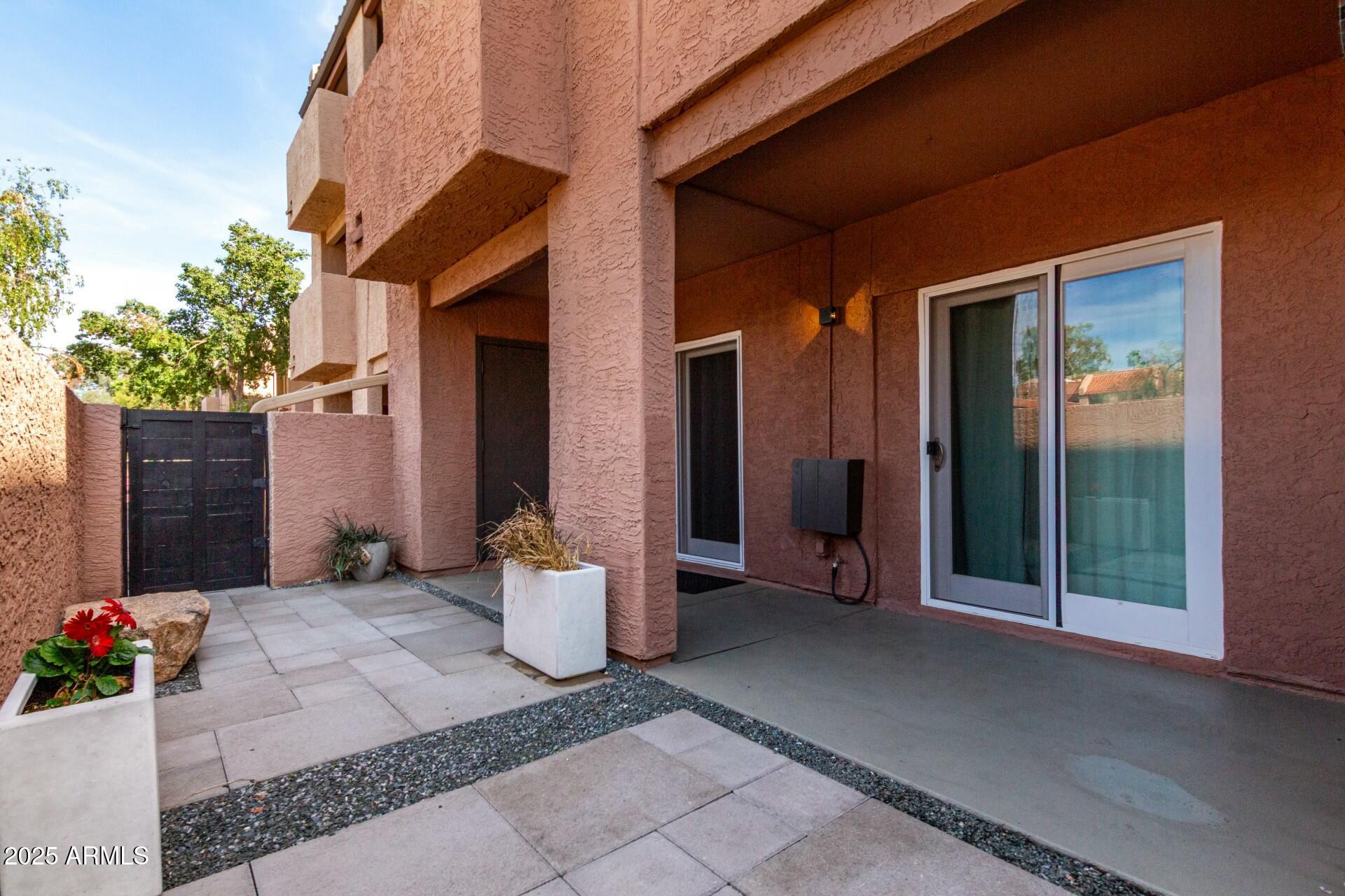 540 North May, Unit 1075 Mesa, AZ 85201 - Photo 2 of 23 a backyard of a house with barbeque oven and brick wall