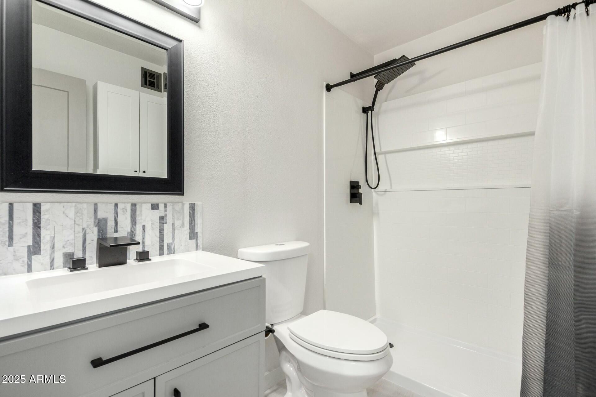 540 North May, Unit 1075 Mesa, AZ 85201 - Photo 22 of 23 a bathroom with a sink a toilet and shower