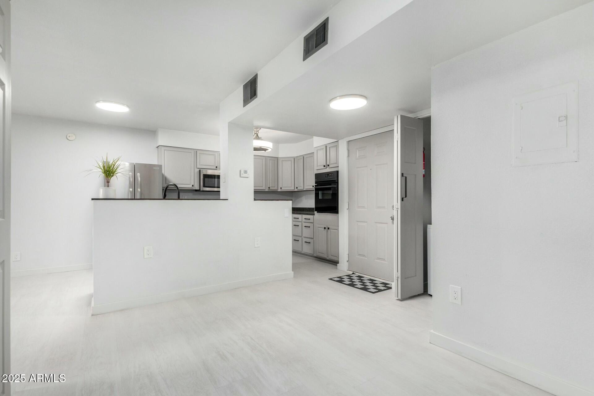 540 North May, Unit 1075 Mesa, AZ 85201 - Photo 9 of 23 a kitchen with stainless steel appliances a refrigerator and a sink