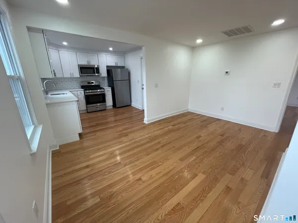 a view of kitchen with sink microwave and refrigerator