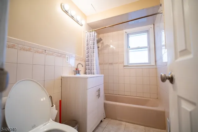 a bathroom with a sink mirror bathtub and toilet