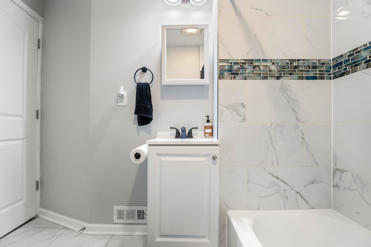1111 Truman Street Hammond, IN 46320 - Photo 13 of 24 a bathroom with a sink and mirror