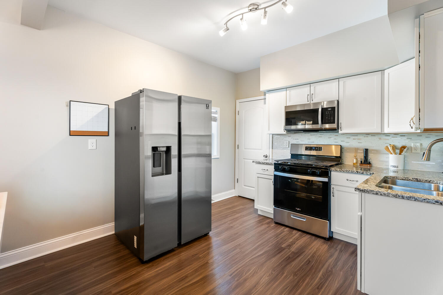 1111 Truman Street Hammond, IN 46320 - Photo 5 of 24 a kitchen with stainless steel appliances a refrigerator stove and microwave