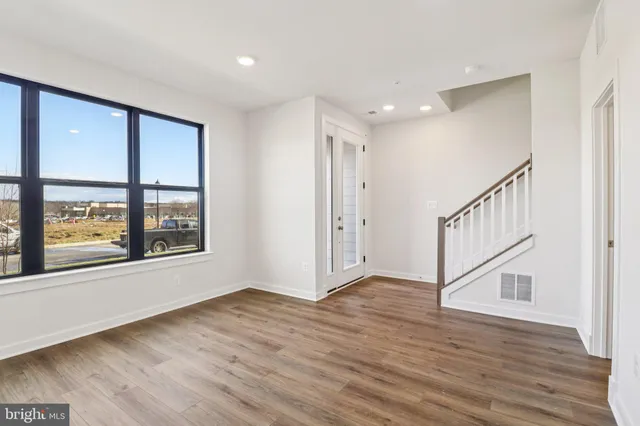 a view of an entryway with wooden floor