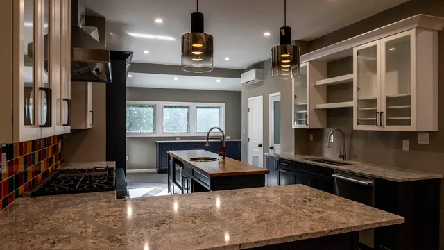 a kitchen with stainless steel appliances granite countertop a sink counter space and a window