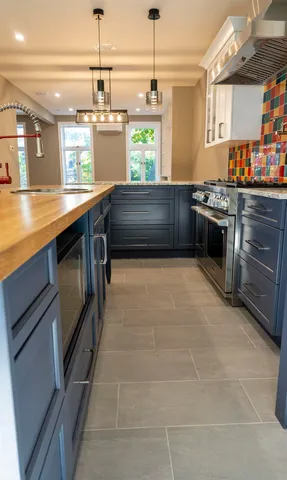 a kitchen with stainless steel appliances granite countertop a stove and a sink