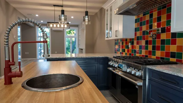 a kitchen with granite countertop a stove and a sink