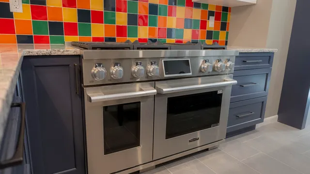 a stove top oven sitting inside of a kitchen