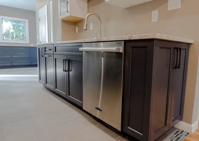 a kitchen with stainless steel appliances granite countertop a refrigerator and a stove