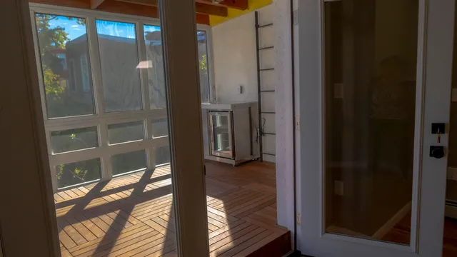 a view of water heater room with wooden floor
