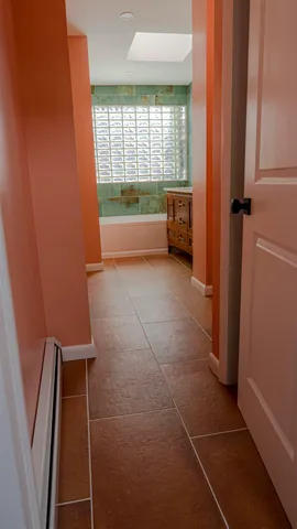 a bathroom with a granite countertop toilet and a bathtub