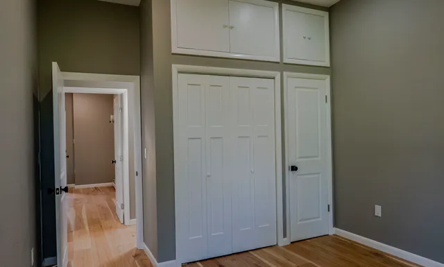 a view of hallway with stairs and wooden floor