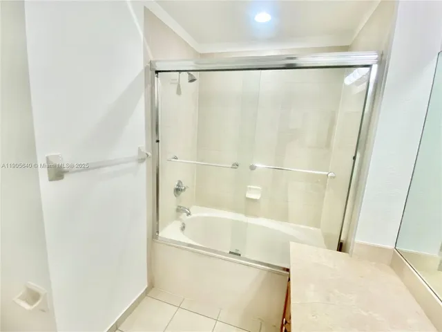 a bathroom with a shower and a bath tub