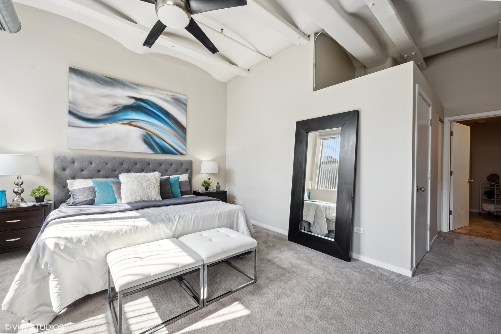 500 South Clinton Street, Unit 410 Chicago, IL 60607 - Photo 11 of 17 a bedroom with a bed and a mirror