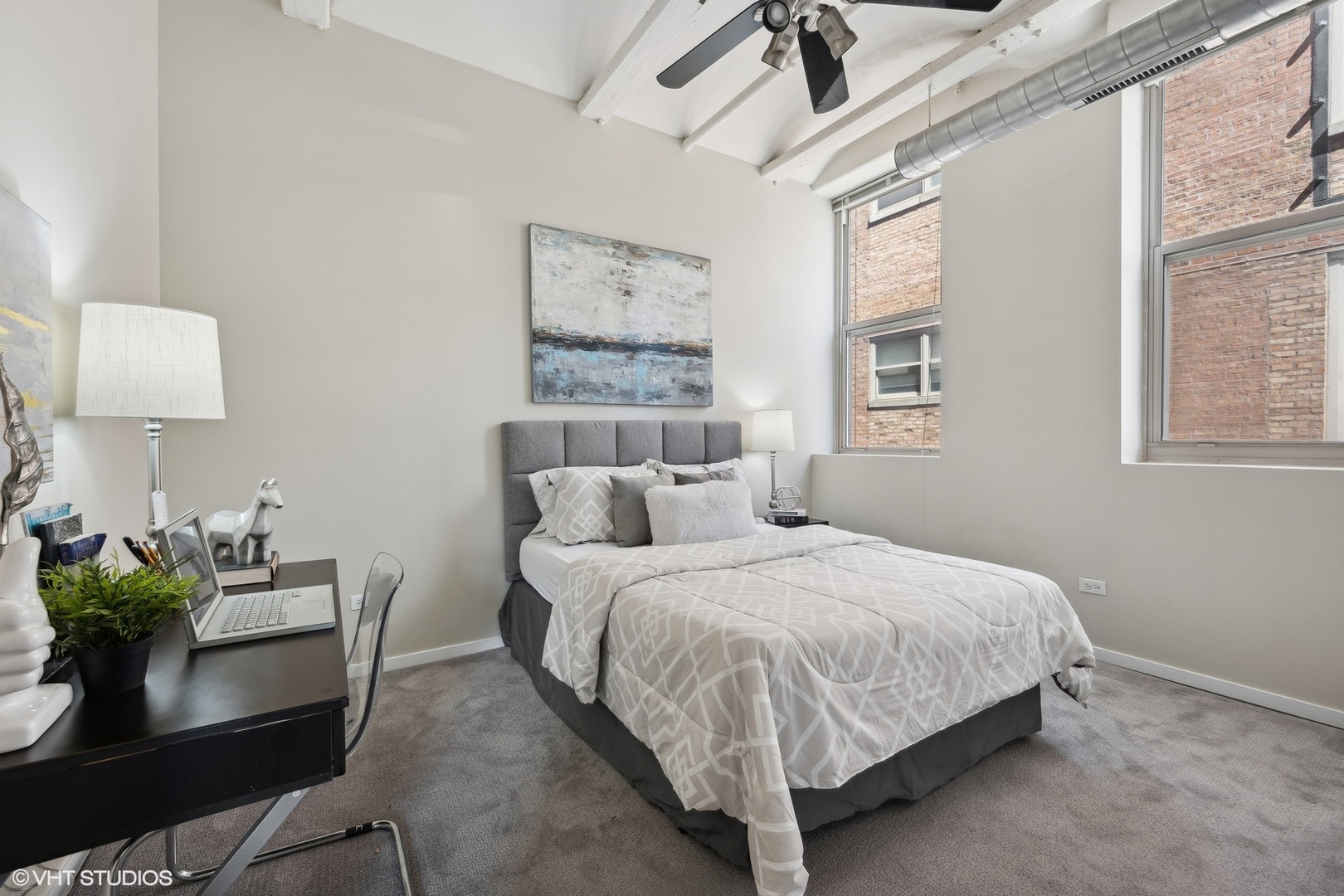 500 South Clinton Street, Unit 410 Chicago, IL 60607 - Photo 13 of 17 a bedroom with a bed table chair and a window