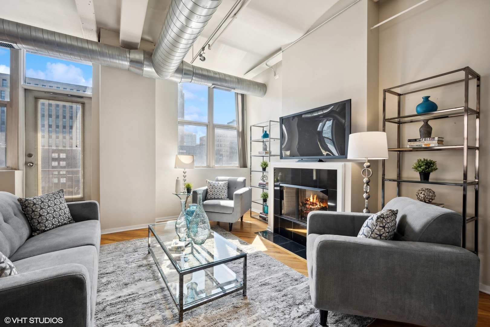 500 South Clinton Street, Unit 410 Chicago, IL 60607 - Photo 3 of 17 a living room with furniture a fireplace and a large window