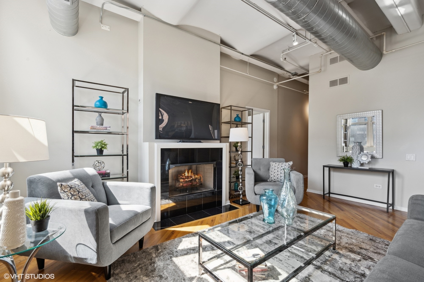 500 South Clinton Street, Unit 410 Chicago, IL 60607 - Photo 4 of 17 a living room with furniture and a fireplace