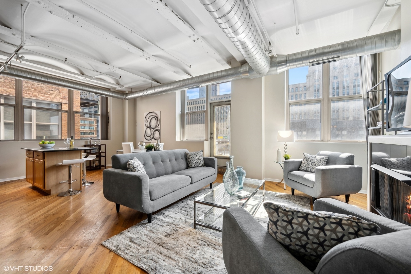 500 South Clinton Street, Unit 410 Chicago, IL 60607 - Photo 5 of 17 a living room with furniture large windows and wooden floor