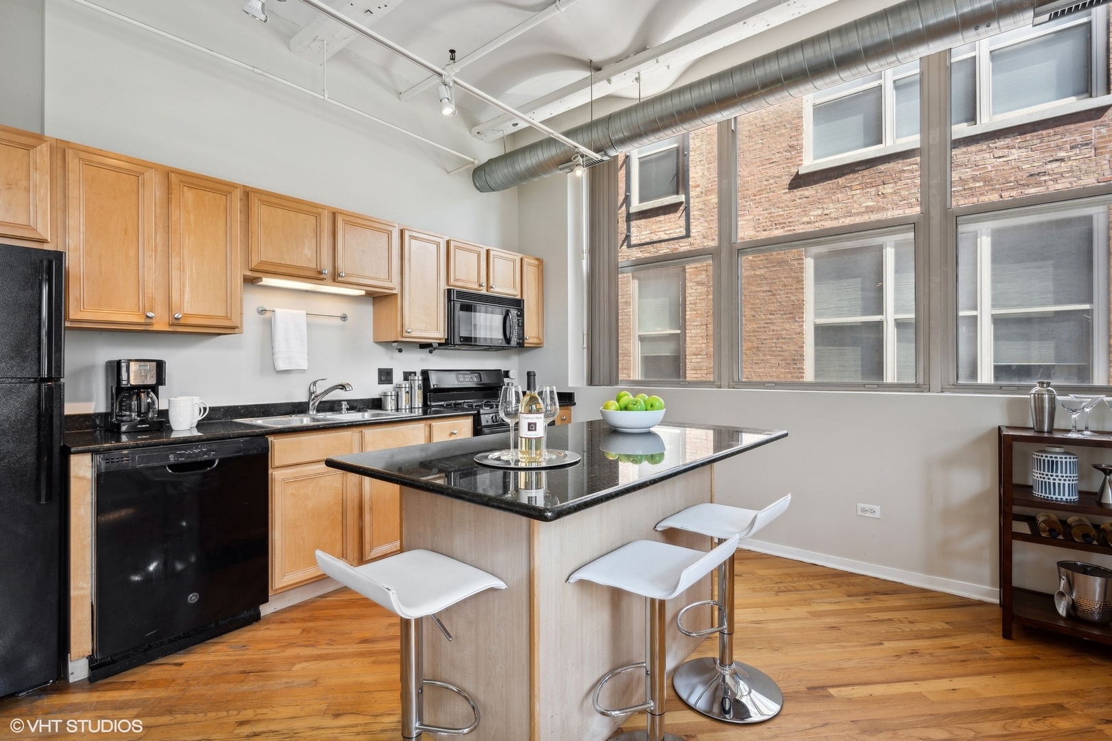 500 South Clinton Street, Unit 410 Chicago, IL 60607 - Photo 6 of 17 a kitchen with stainless steel appliances granite countertop a stove a sink dishwasher a microwave oven with granite countertops and cabinets