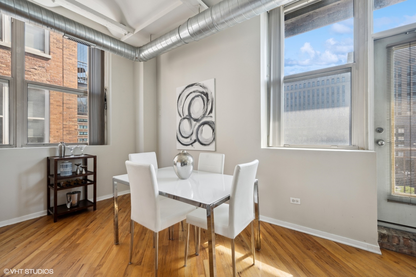 500 South Clinton Street, Unit 410 Chicago, IL 60607 - Photo 9 of 17 a view of a dining room with furniture window and wooden floor
