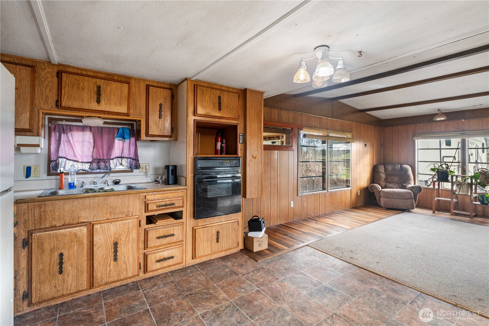3090 Cole Road Everson, WA 98247 - Photo 4 of 22 a living room with furniture a chandelier and a flat screen tv