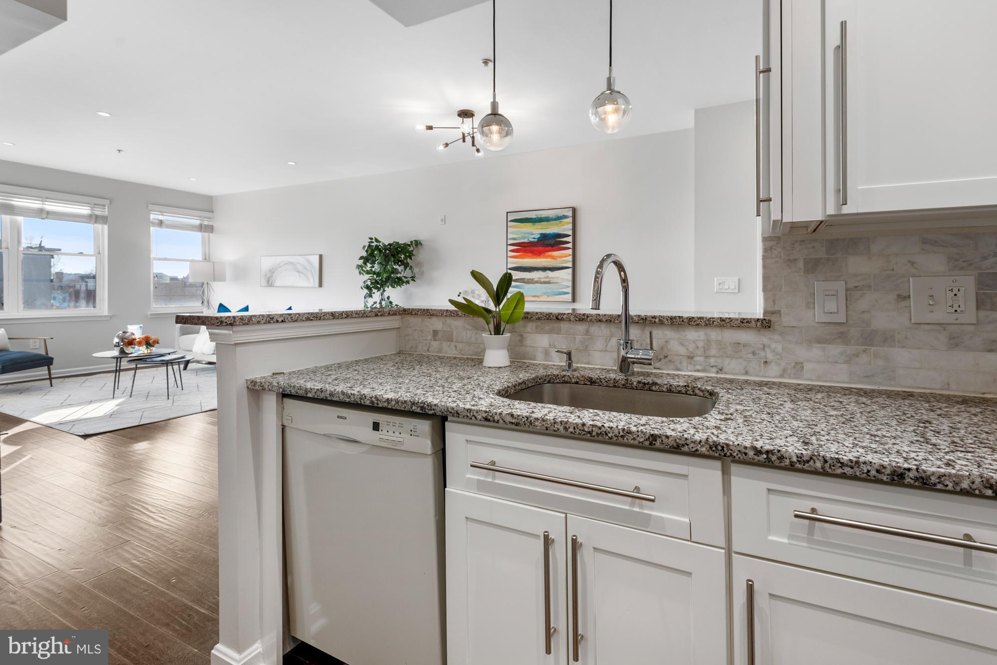 2001 12th Street Northwest, Unit 306 Washington, DC 20009 - Photo 12 of 36 a kitchen with sink stove and cabinets
