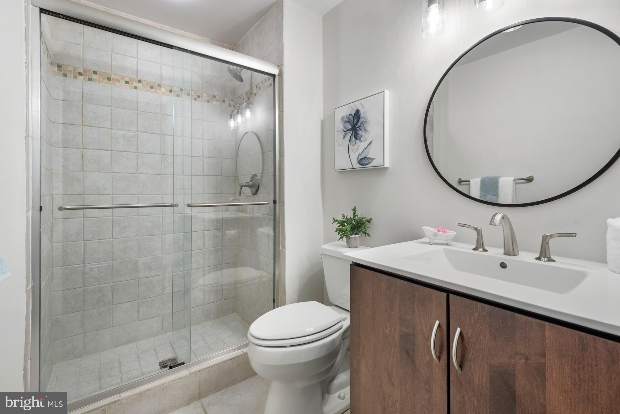 2001 12th Street Northwest, Unit 306 Washington, DC 20009 - Photo 14 of 36 a bathroom with a sink toilet and shower