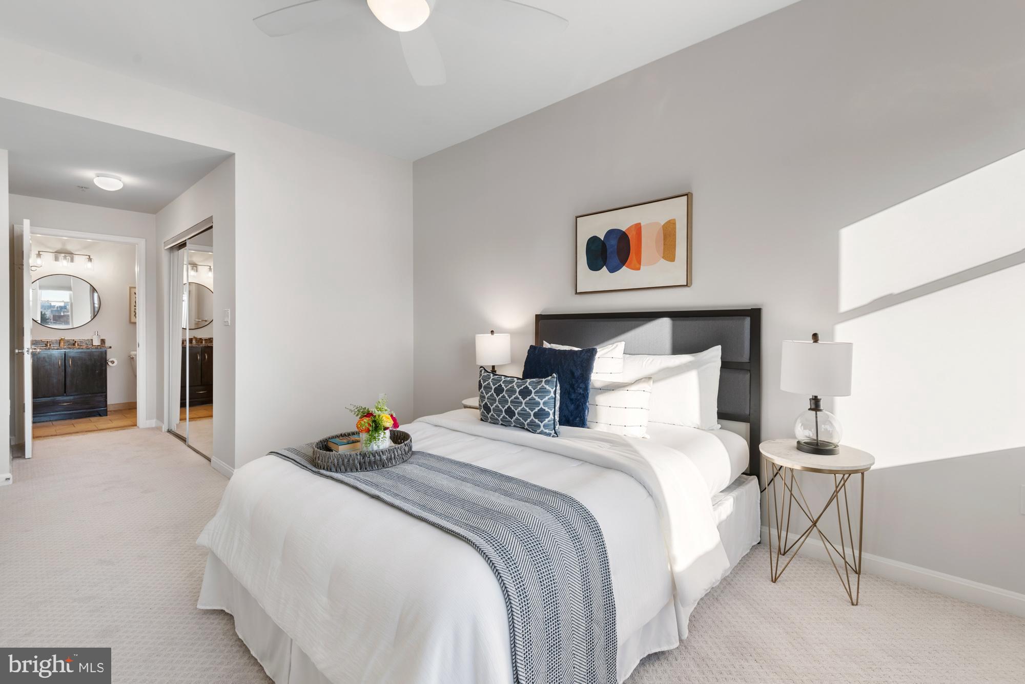 2001 12th Street Northwest, Unit 306 Washington, DC 20009 - Photo 17 of 36 a bedroom with a bed and glass windows