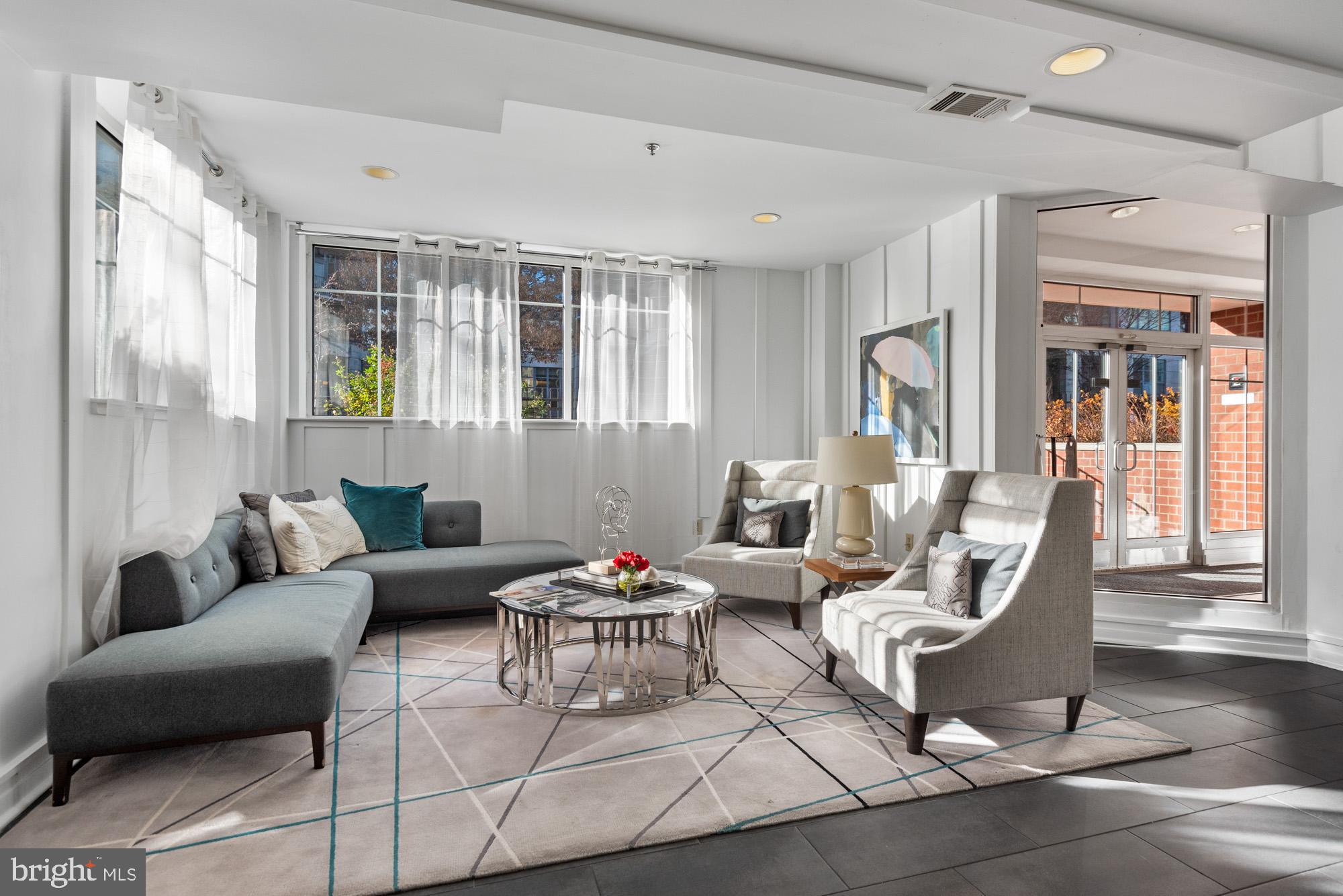 2001 12th Street Northwest, Unit 306 Washington, DC 20009 - Photo 22 of 36 a living room with furniture and a potted plant
