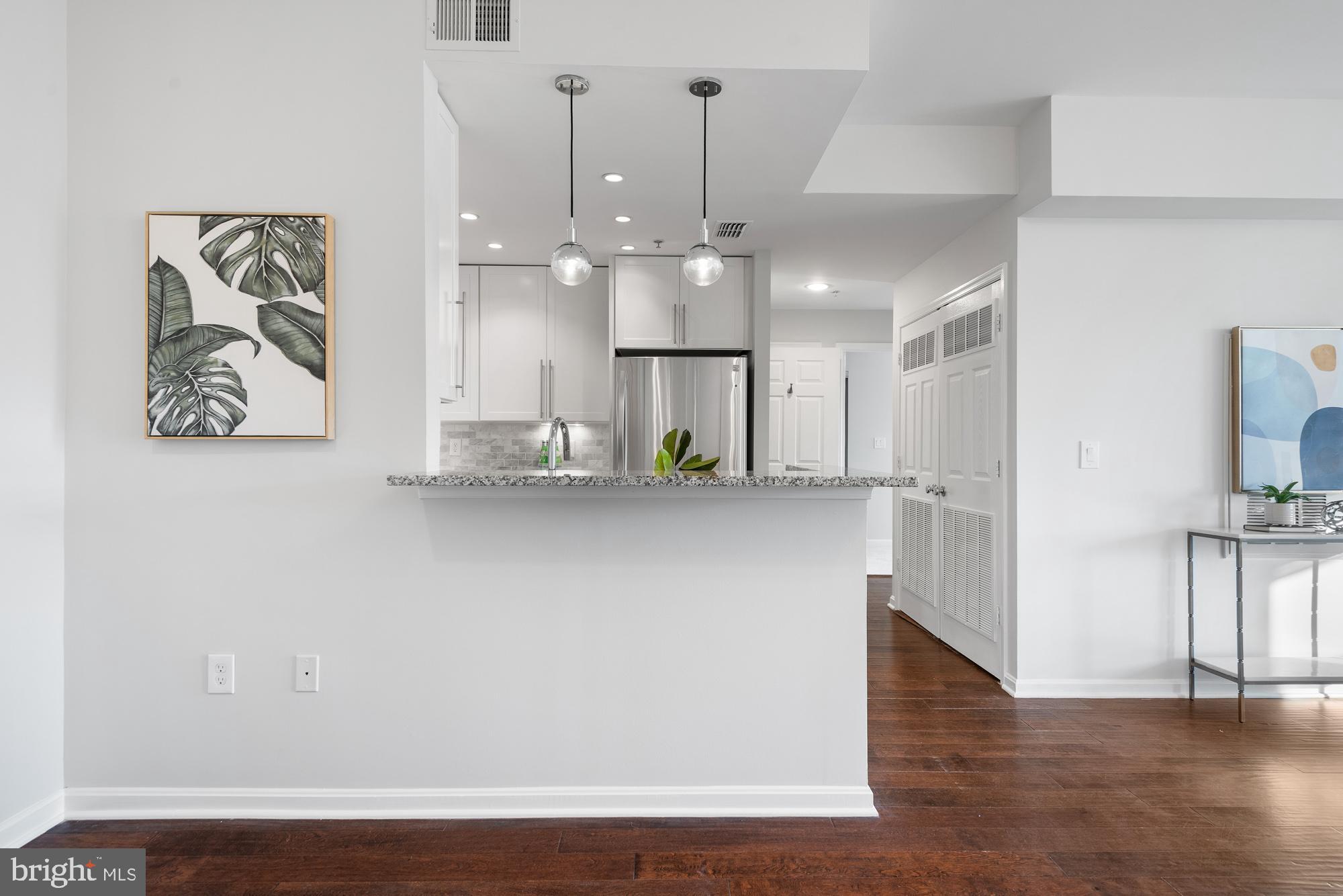 2001 12th Street Northwest, Unit 306 Washington, DC 20009 - Photo 7 of 36 a view of a kitchen with furniture and wooden floor