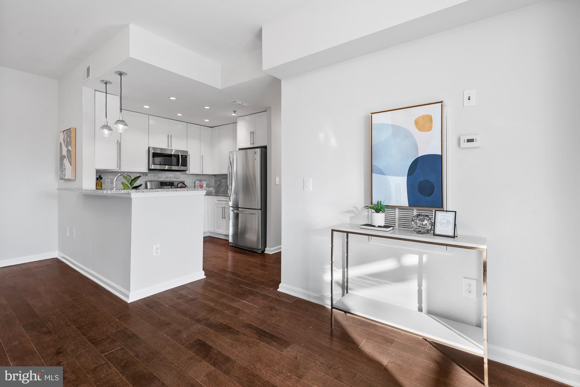 2001 12th Street Northwest, Unit 306 Washington, DC 20009 - Photo 9 of 36 a kitchen with stainless steel appliances granite countertop a refrigerator and a stove top oven