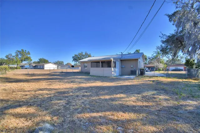 a front view of a house with a yard and road view