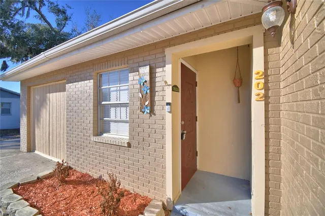 a view of a brick house with a large windows