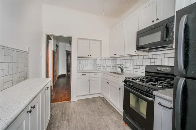 a kitchen with stainless steel appliances a sink stove and microwave