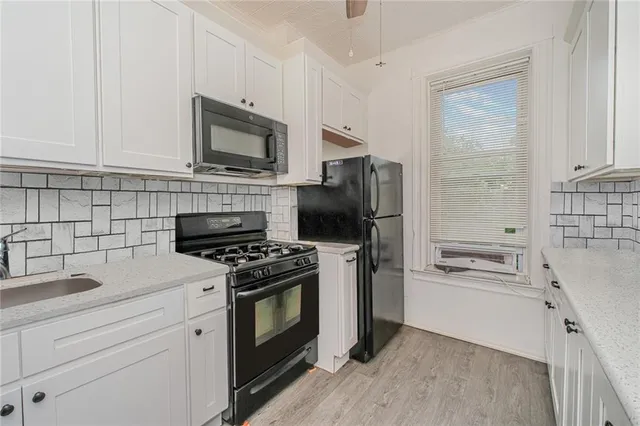 a kitchen with cabinets stainless steel appliances and a counter space