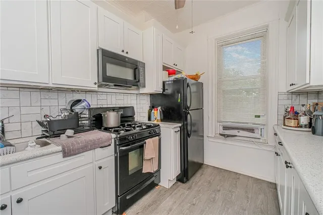 a kitchen with stainless steel appliances granite countertop a refrigerator stove and sink