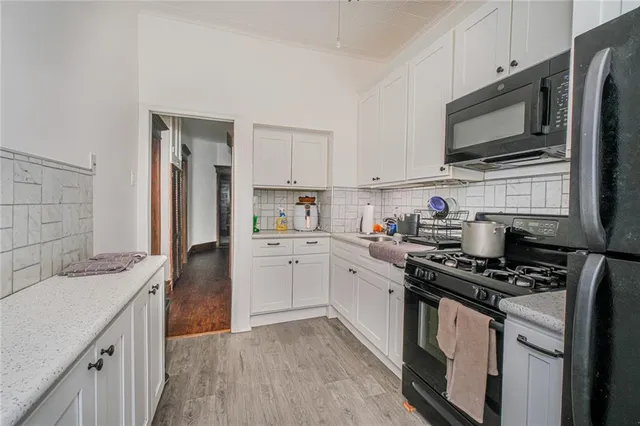 a kitchen with stainless steel appliances a sink dishwasher stove microwave and refrigerator