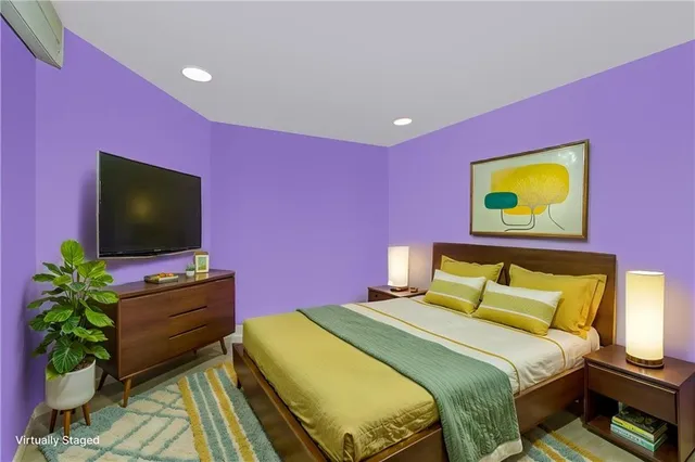 a bedroom with a bed and a flat screen tv